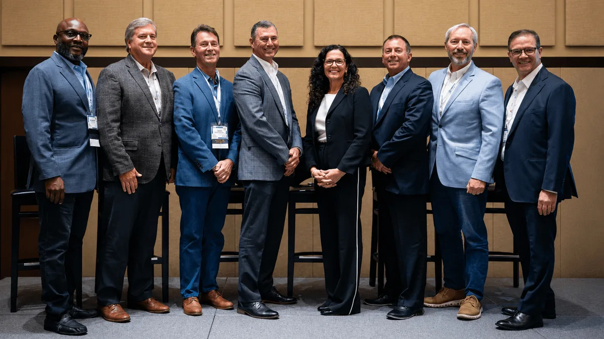 Eight NERUCA members standing together at a conference session